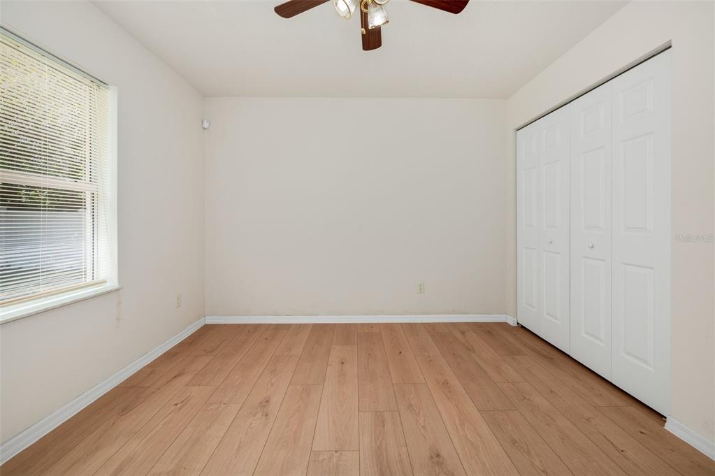 5090 Southeast 28th Street Ocala, FL 34480 - Photo 26 of 35 a view of an empty room with wooden floor and a window