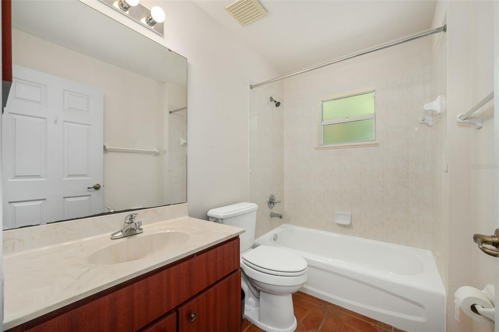 5090 Southeast 28th Street Ocala, FL 34480 - Photo 27 of 35 a bathroom with a sink a toilet and shower
