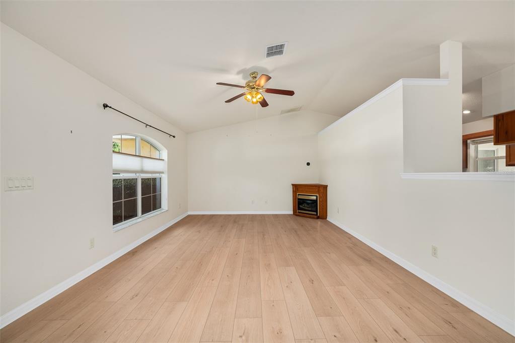 5090 Southeast 28th Street Ocala, FL 34480 - Photo 5 of 35 wooden floor in an empty room with a window