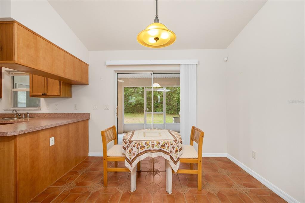 5090 Southeast 28th Street Ocala, FL 34480 - Photo 8 of 35 a view of a kitchen area with furniture and floor to ceiling window