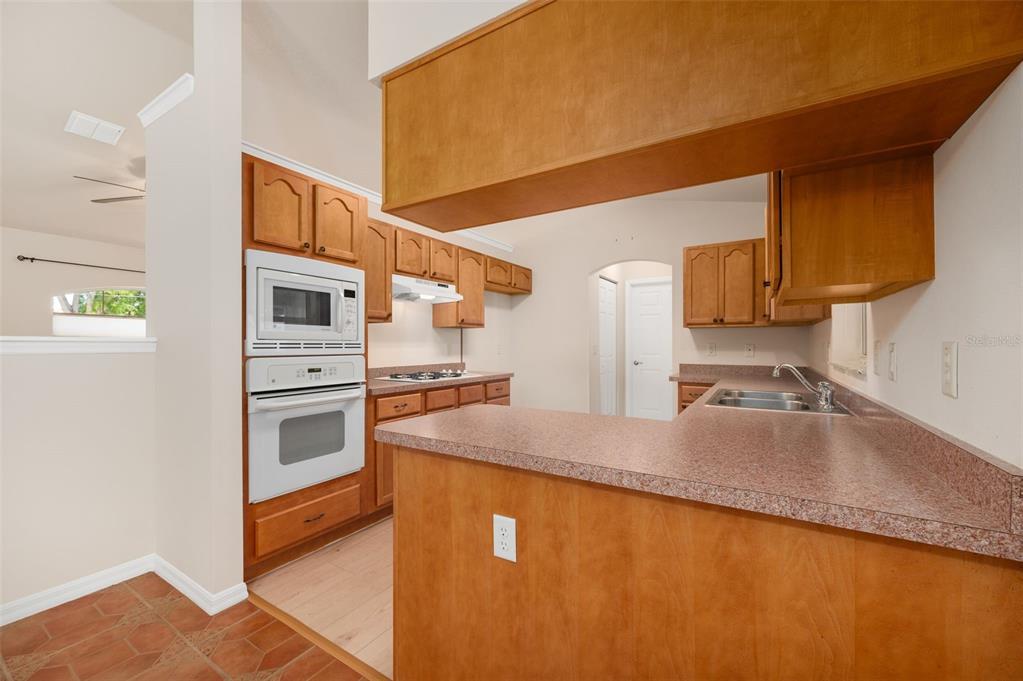5090 Southeast 28th Street Ocala, FL 34480 - Photo 9 of 35 a kitchen with stainless steel appliances granite countertop a sink a stove and a refrigerator