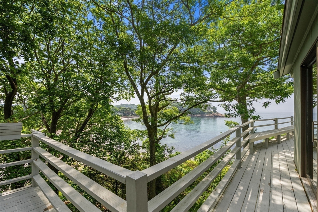 23 Ocean Street Manchester, MA 01944 - Photo 8 of 36 a view of a balcony with wooden floor and fence