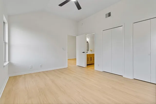 a view of an empty room with a kitchen