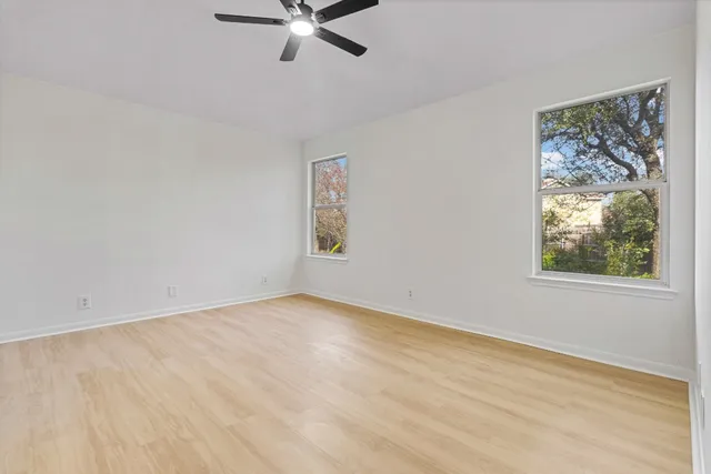 a view of a room with wooden floor and window