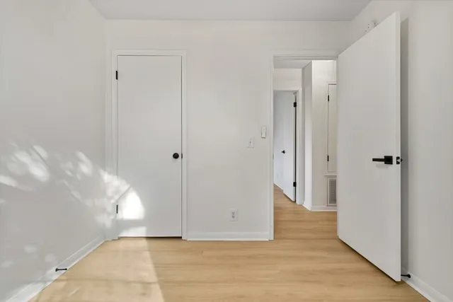 a view of hallway with wooden floor