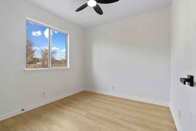 wooden floor in an empty room with a window