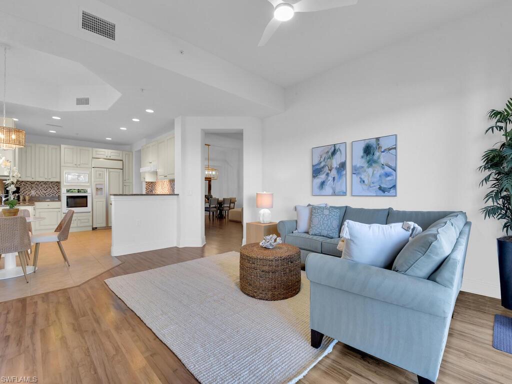 2710 Callista Court, Unit 104 Naples, FL 34114 - Photo 16 of 43 Living area featuring recessed lighting, ceiling fan with notable chandelier, baseboards, visible vents, and light wood-style flooring