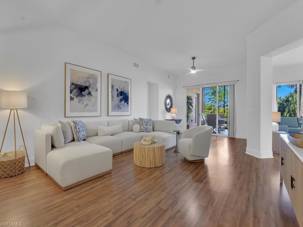 2710 Callista Court, Unit 104 Naples, FL 34114 - Photo 6 of 43 Living area with visible vents, baseboards, ceiling fan, and wood finished floors