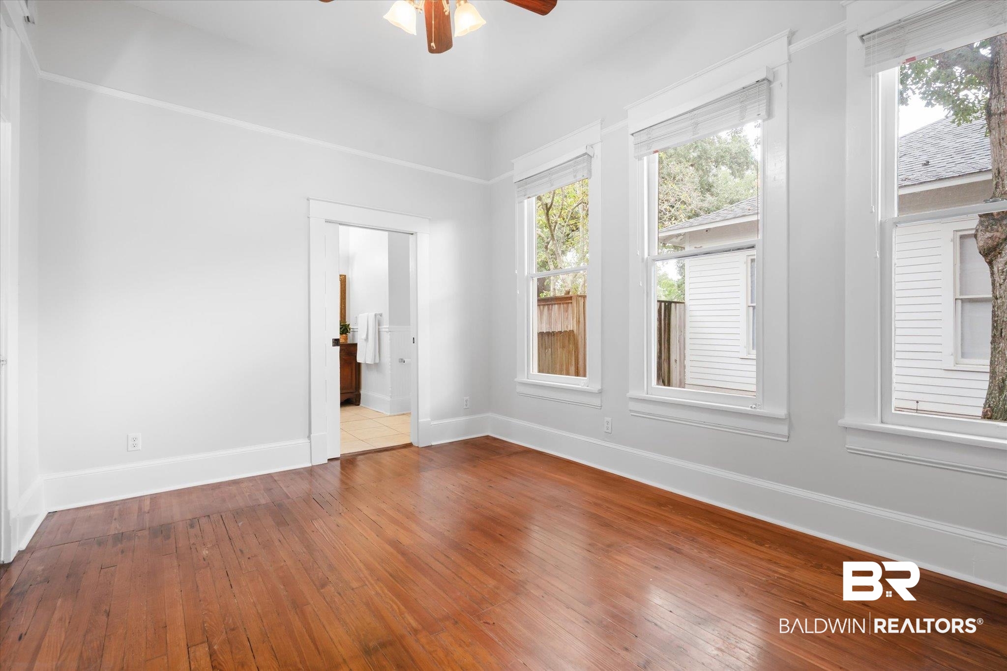 14 South Monterey Street Mobile, AL 36604 - Photo 11 of 41 Empty room featuring light hardwood / wood-style flooring, ceiling fan, and plenty of natural light