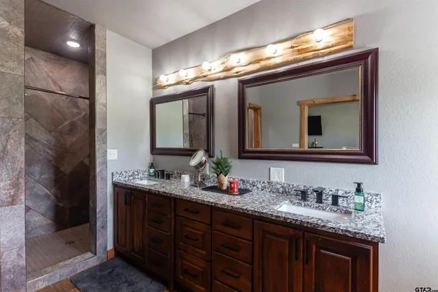 a bathroom with a double vanity sink and a mirror