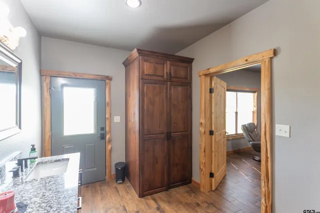 a view of a hallway with wooden floor windows and a livingroom
