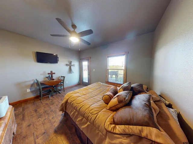 a bedroom with a bed and a large window