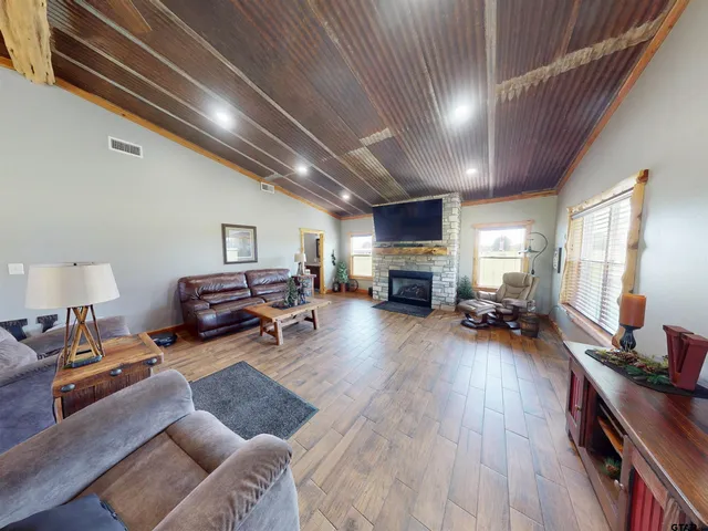 a living room with furniture hard wood floor and furniture
