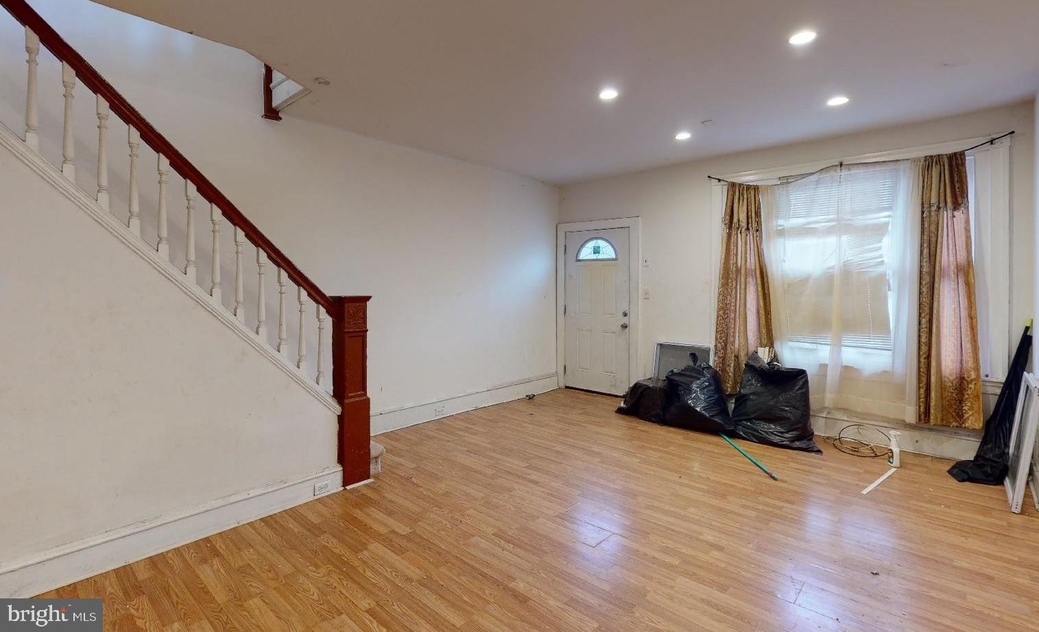 3936 North 8th Street Philadelphia, PA 19140 - Photo 3 of 5 a view of a room with wooden floor and stairs