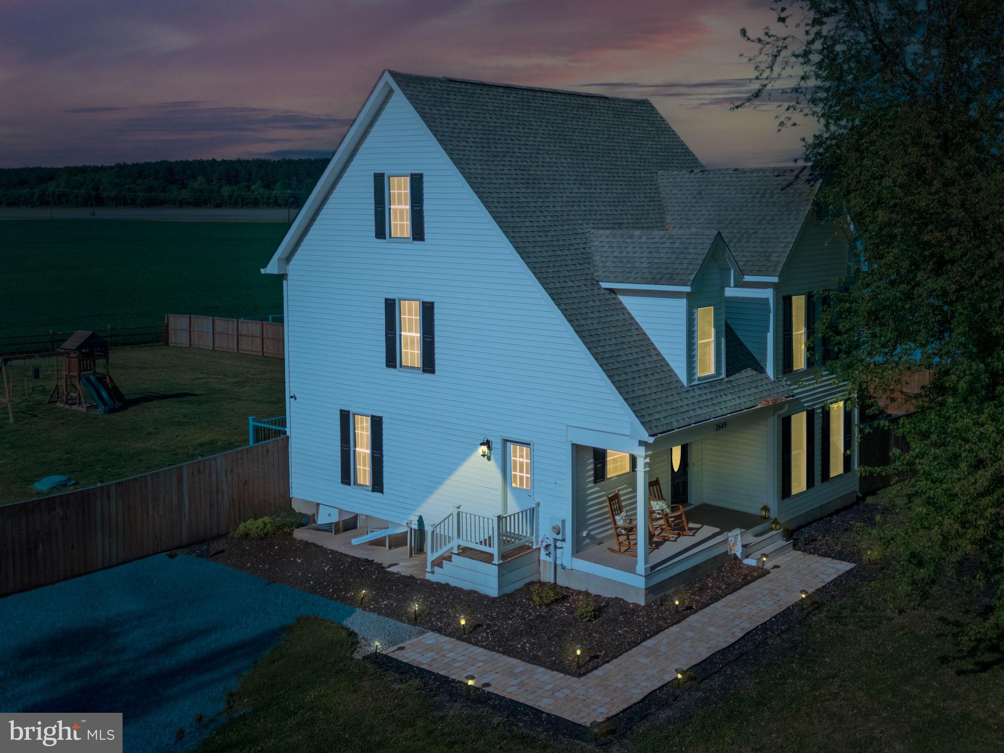 Charming blue home at twilight glow.