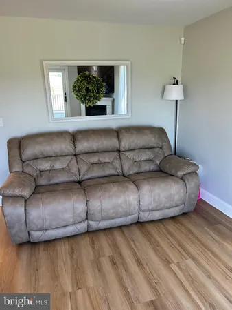 a living room with a couch and a chandelier