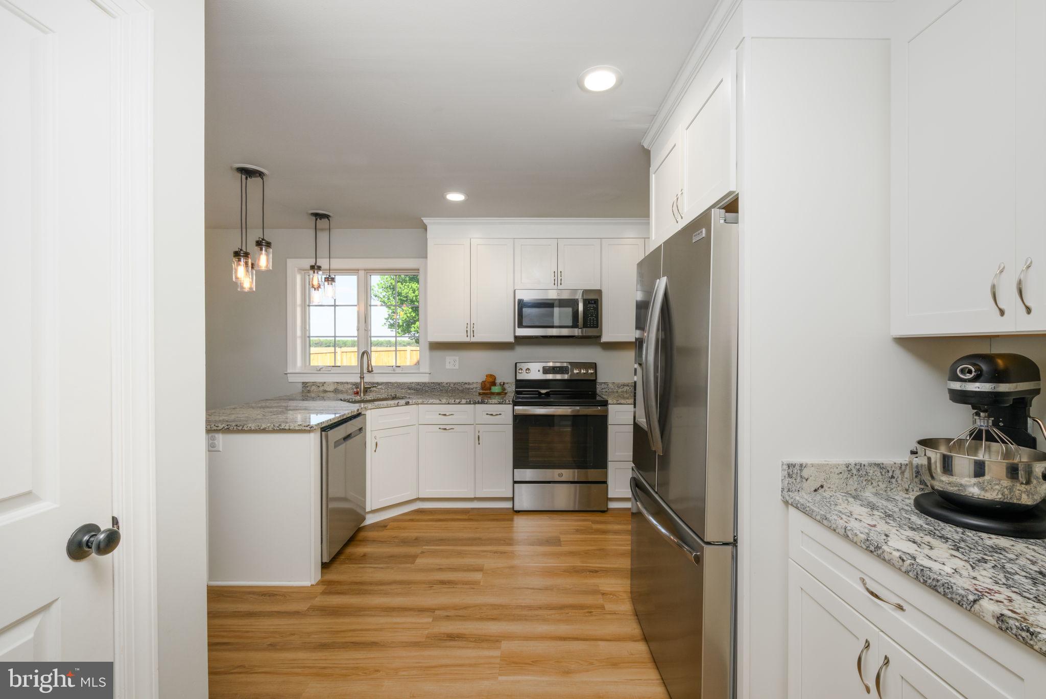 2649 Roberts Station Road Ingleside, MD 21644 - Photo 15 of 47 a kitchen with granite countertop stainless steel appliances and wooden cabinets