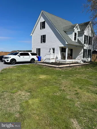 a view of a house with pool and chairs