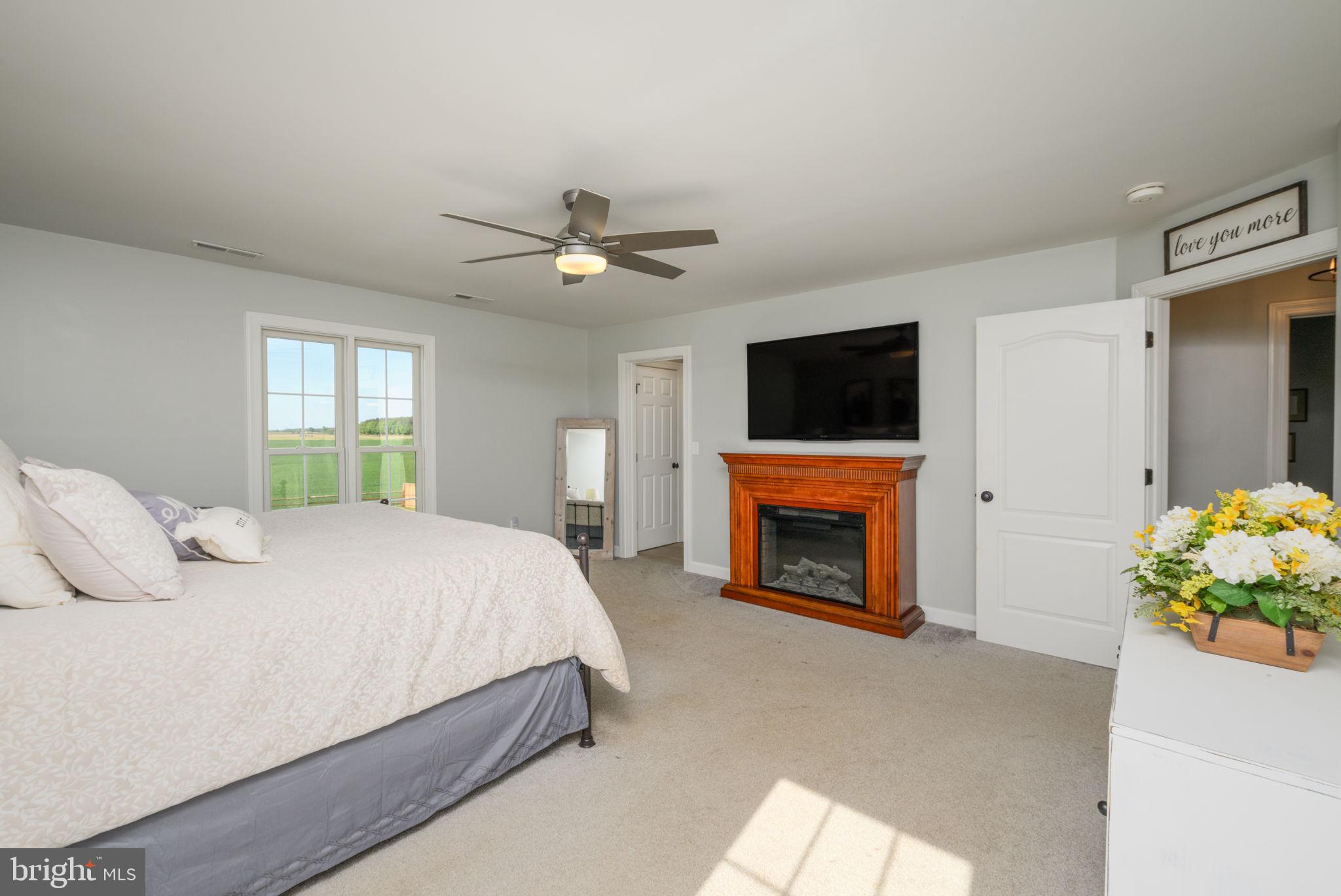 2649 Roberts Station Road Ingleside, MD 21644 - Photo 31 of 47 a bedroom with a bed and a fireplace