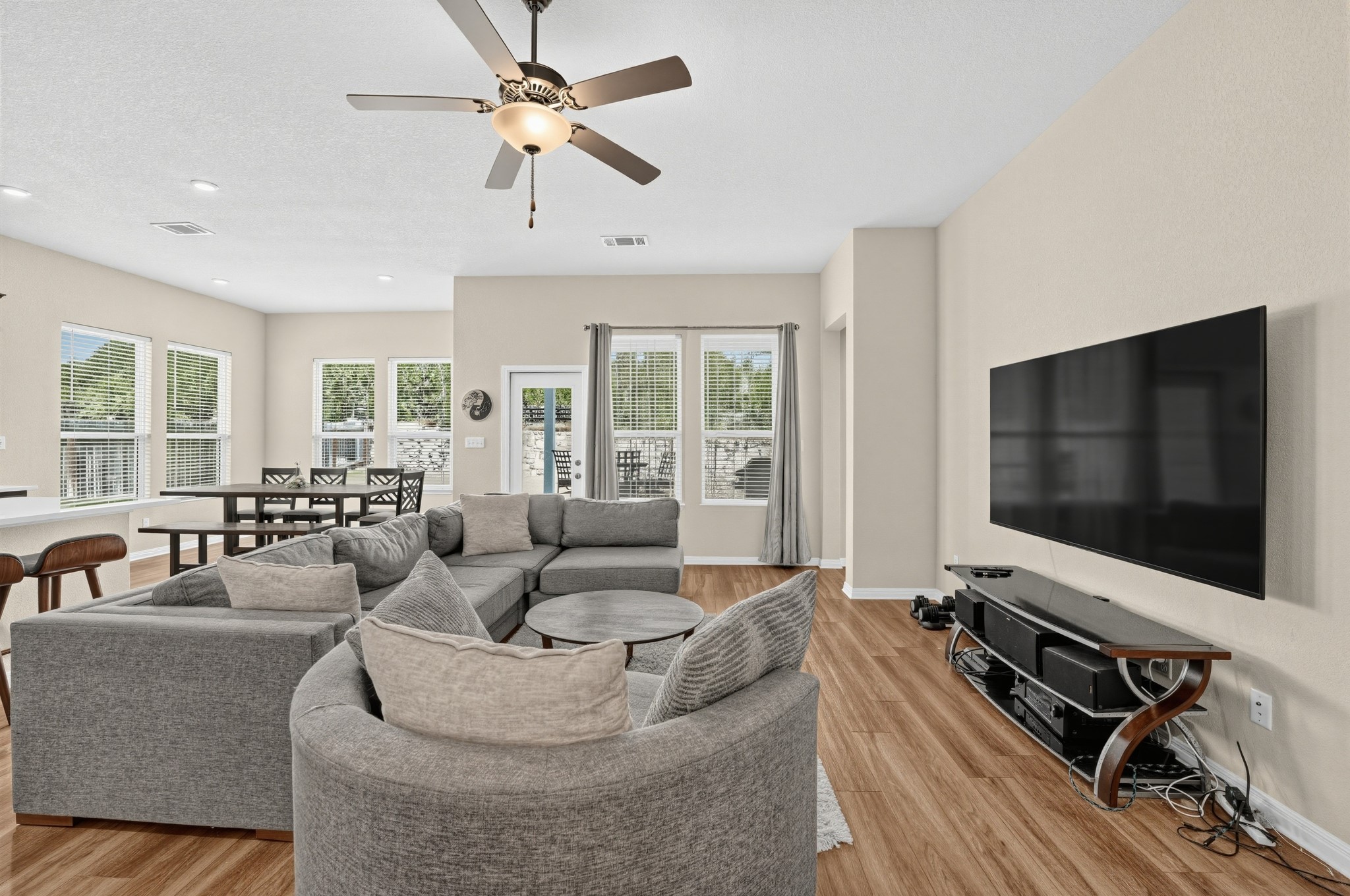 145 Brooks Ranchi Drive Kyle, TX 78640 - Photo 12 of 40 Gleaming hardwood floors and a wall of windows define this spacious open living area.