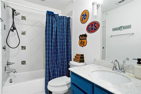 a bathroom with a sink a toilet and a shower