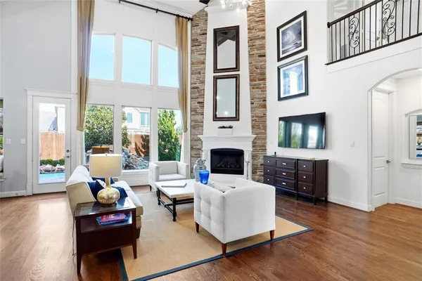 a living room with furniture large window and a fireplace