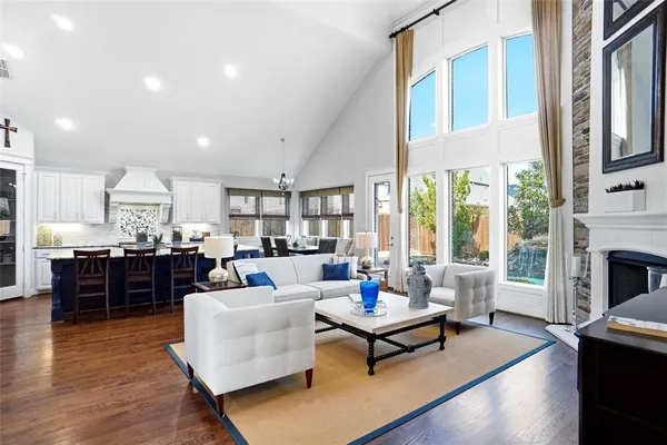 a living room with furniture fireplace and a table