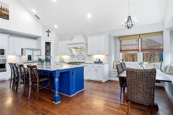 a dining room with furniture a window and wooden floor