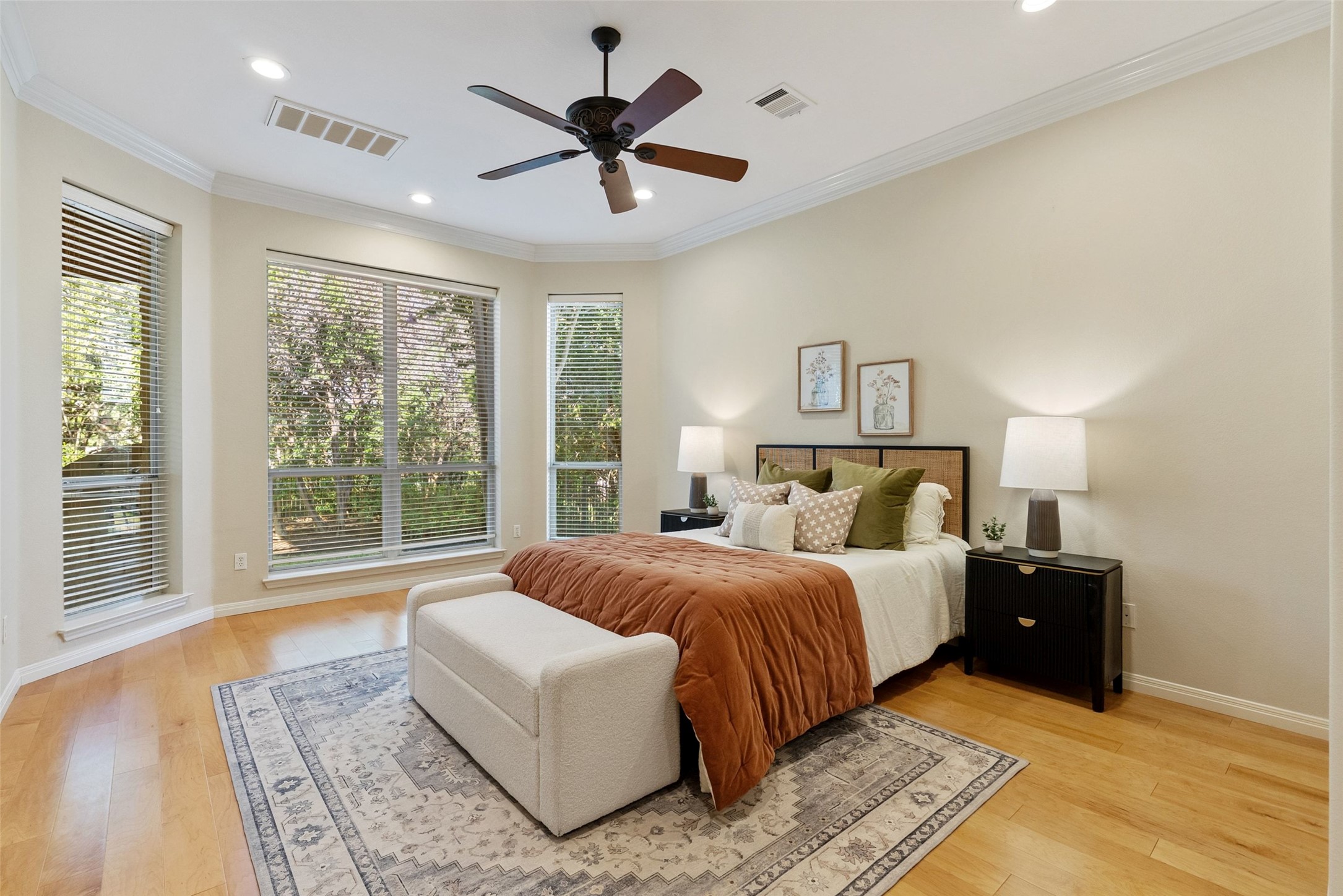 8215 Dark Ridge Cove Austin, TX 78737 - Photo 17 of 40 Hardwood flooring, recessed lighting, and numerous windows define this sun-filled primary bedroom retreat.