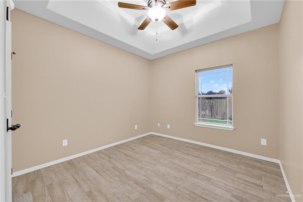 2005 Stuart Road Weslaco, TX 78599 - Photo 21 of 30 a view of an empty room with window and a ceiling fan