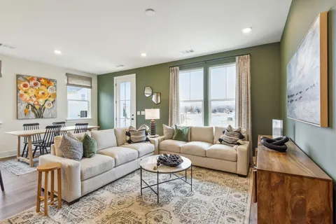 a living room with furniture and large windows