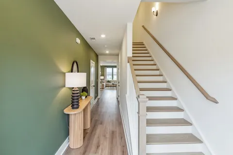a view of entryway and hall with wooden floor