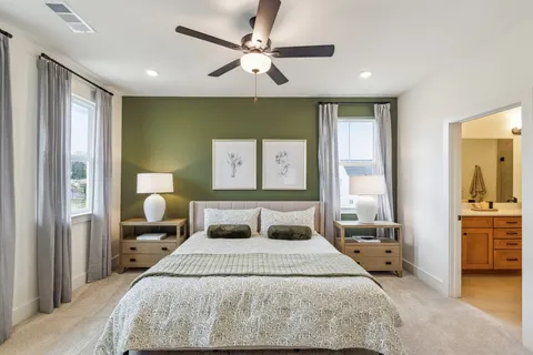 a bedroom with a large bed and a chandelier