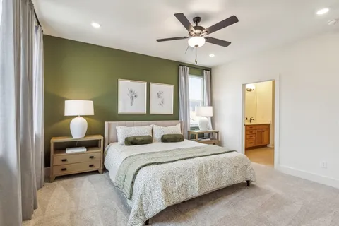 a bedroom with double bed and a chandelier