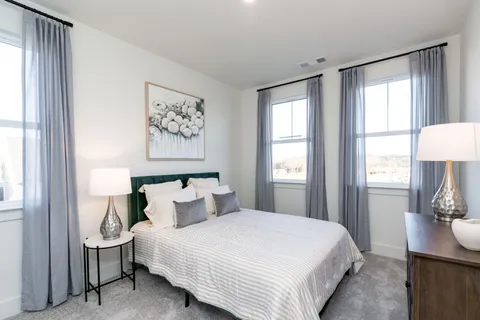 a bedroom with a bed and a lamp on table