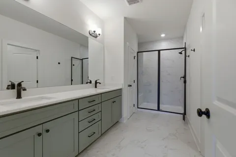 a spacious bathroom with a double vanity sink mirror and double