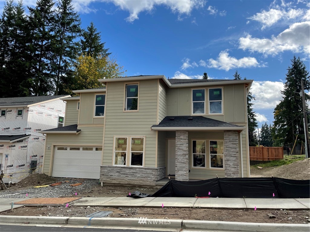 14 215th Street Southeast, Unit 13 Bothell, WA 98021 - Photo 1 of 15 a front view of a house with a yard and potted plants