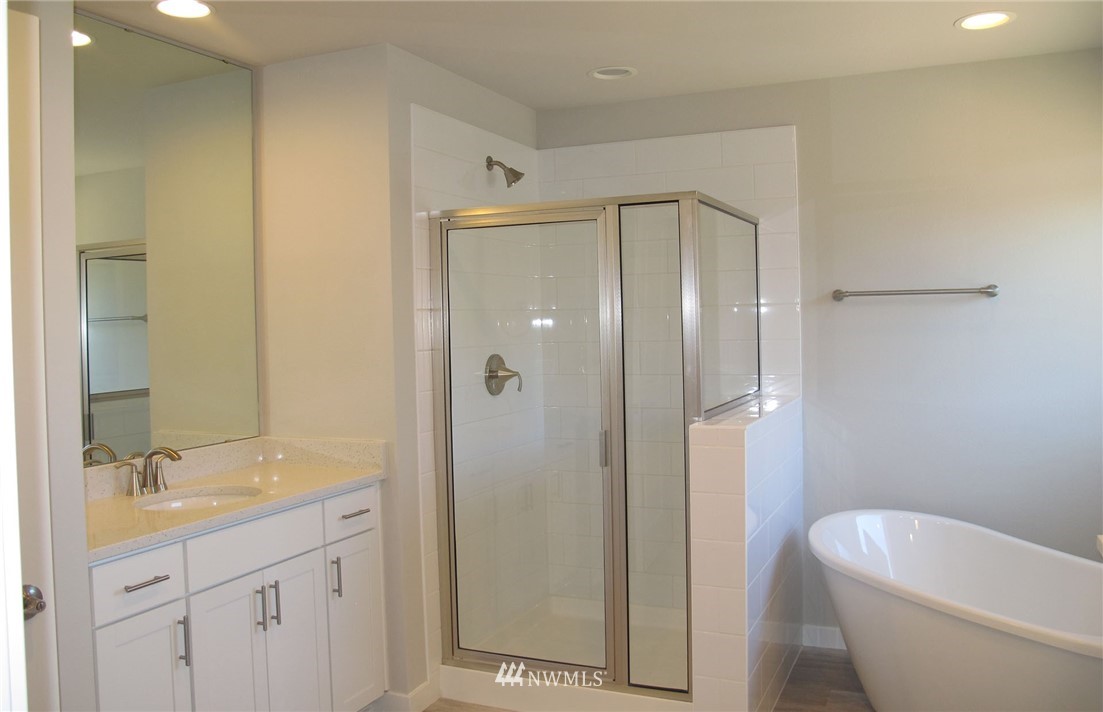 14 215th Street Southeast, Unit 13 Bothell, WA 98021 - Photo 14 of 15 a bathroom with a granite countertop sink a toilet and shower