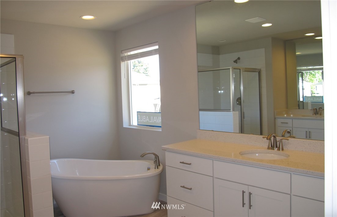 14 215th Street Southeast, Unit 13 Bothell, WA 98021 - Photo 15 of 15 a bathroom with a granite countertop sink a toilet and a mirror