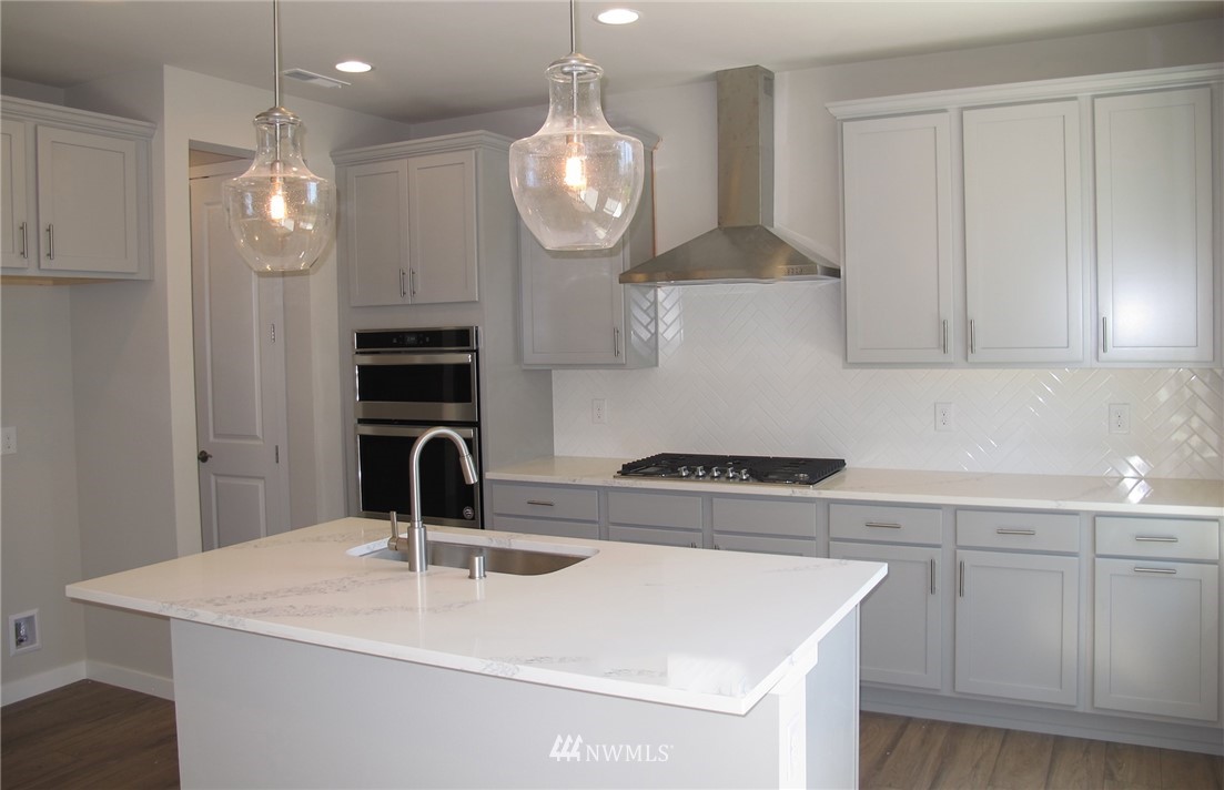 14 215th Street Southeast, Unit 13 Bothell, WA 98021 - Photo 8 of 15 a kitchen with cabinets and white stainless steel appliances