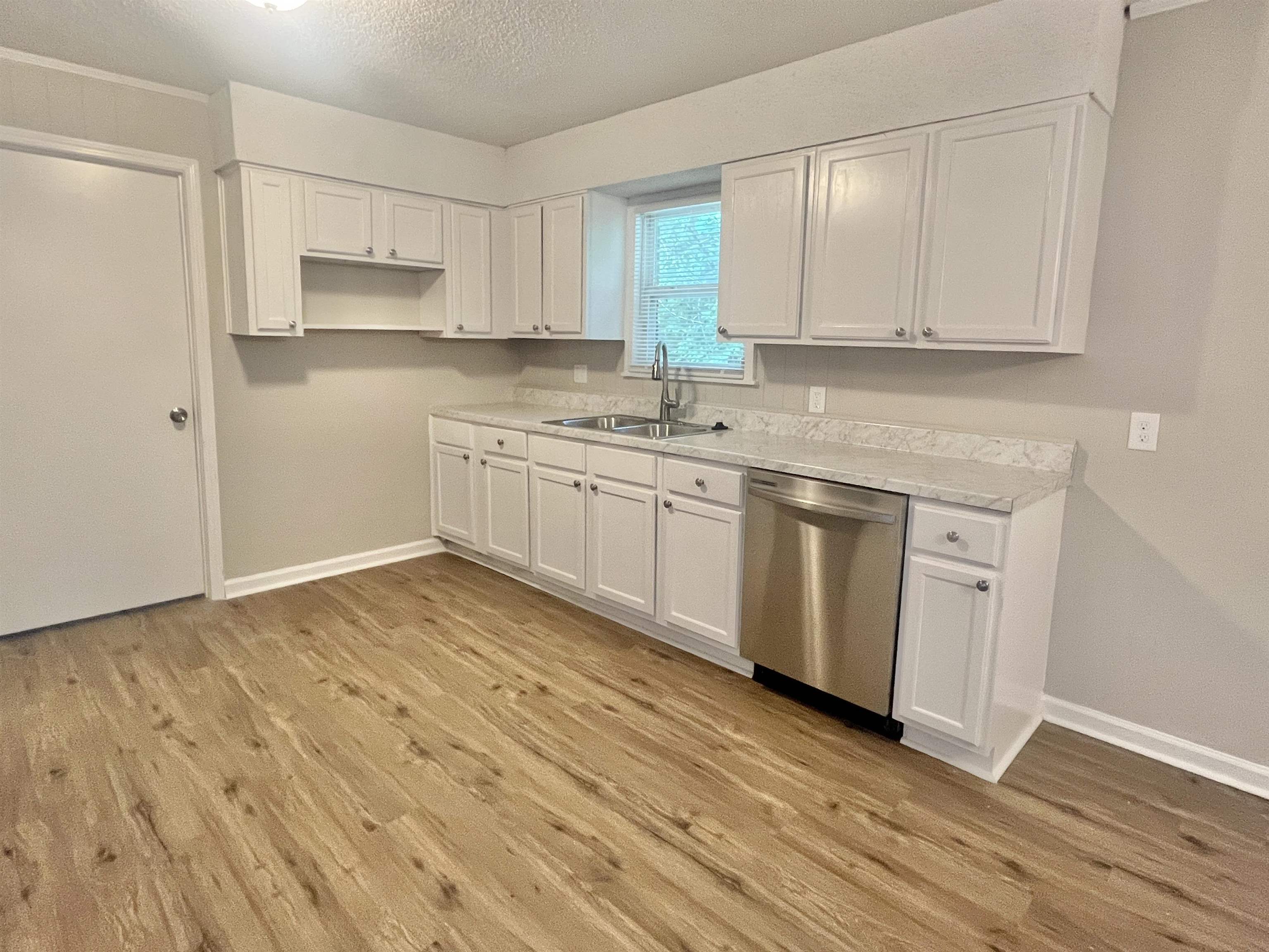 1172 Tabernacle Road Covington, TN 38019 - Photo 4 of 13 a kitchen with stainless steel appliances granite countertop a stove a sink and white cabinets