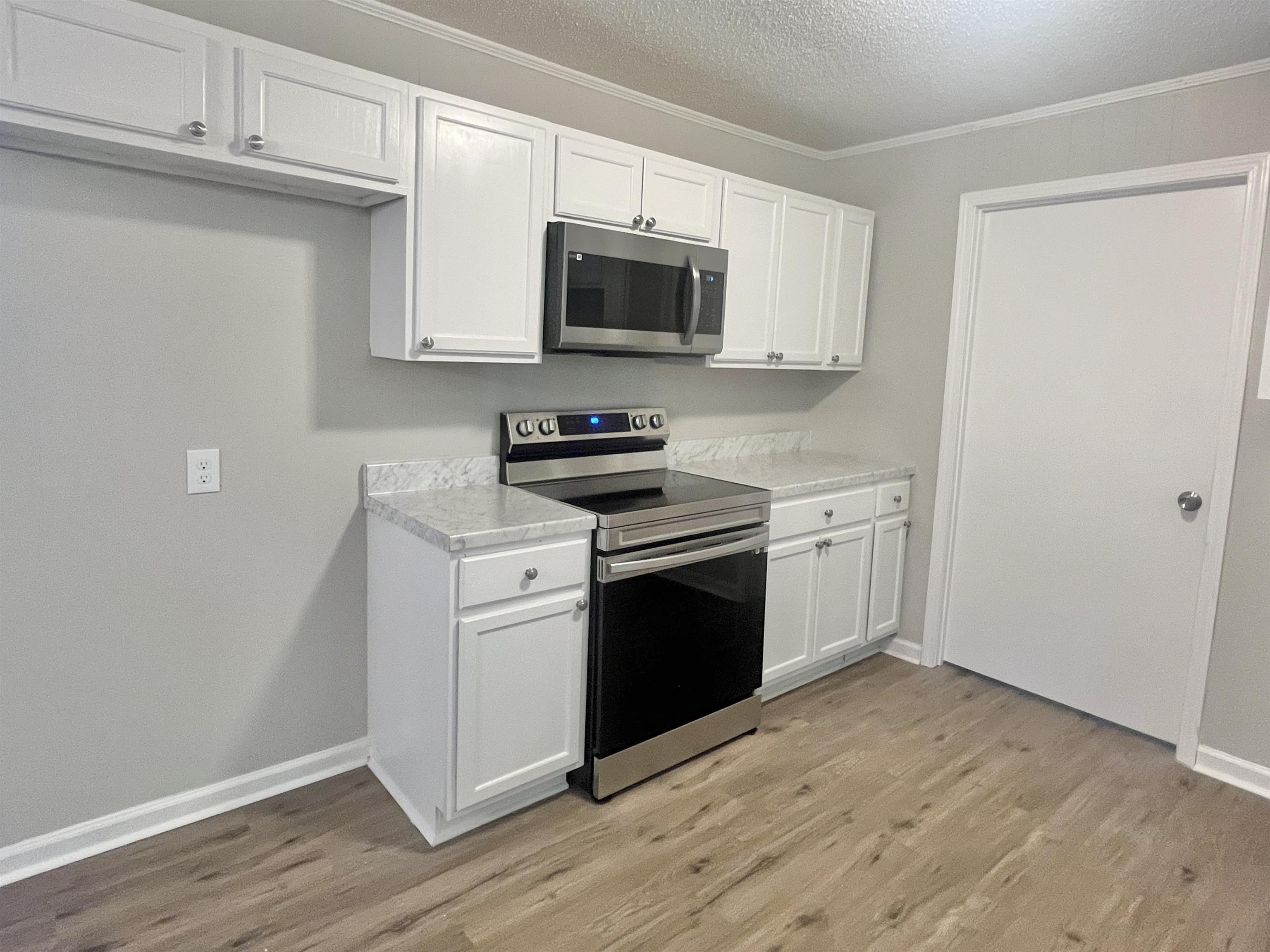 1172 Tabernacle Road Covington, TN 38019 - Photo 5 of 13 a kitchen with a sink stove and microwave