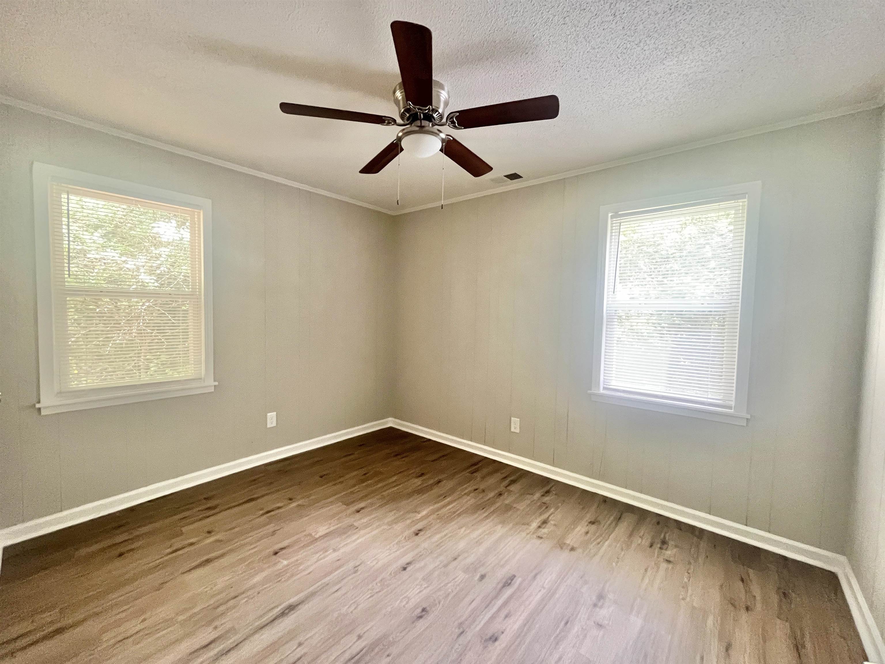 1172 Tabernacle Road Covington, TN 38019 - Photo 10 of 13 a view of empty room with wooden floor and fan