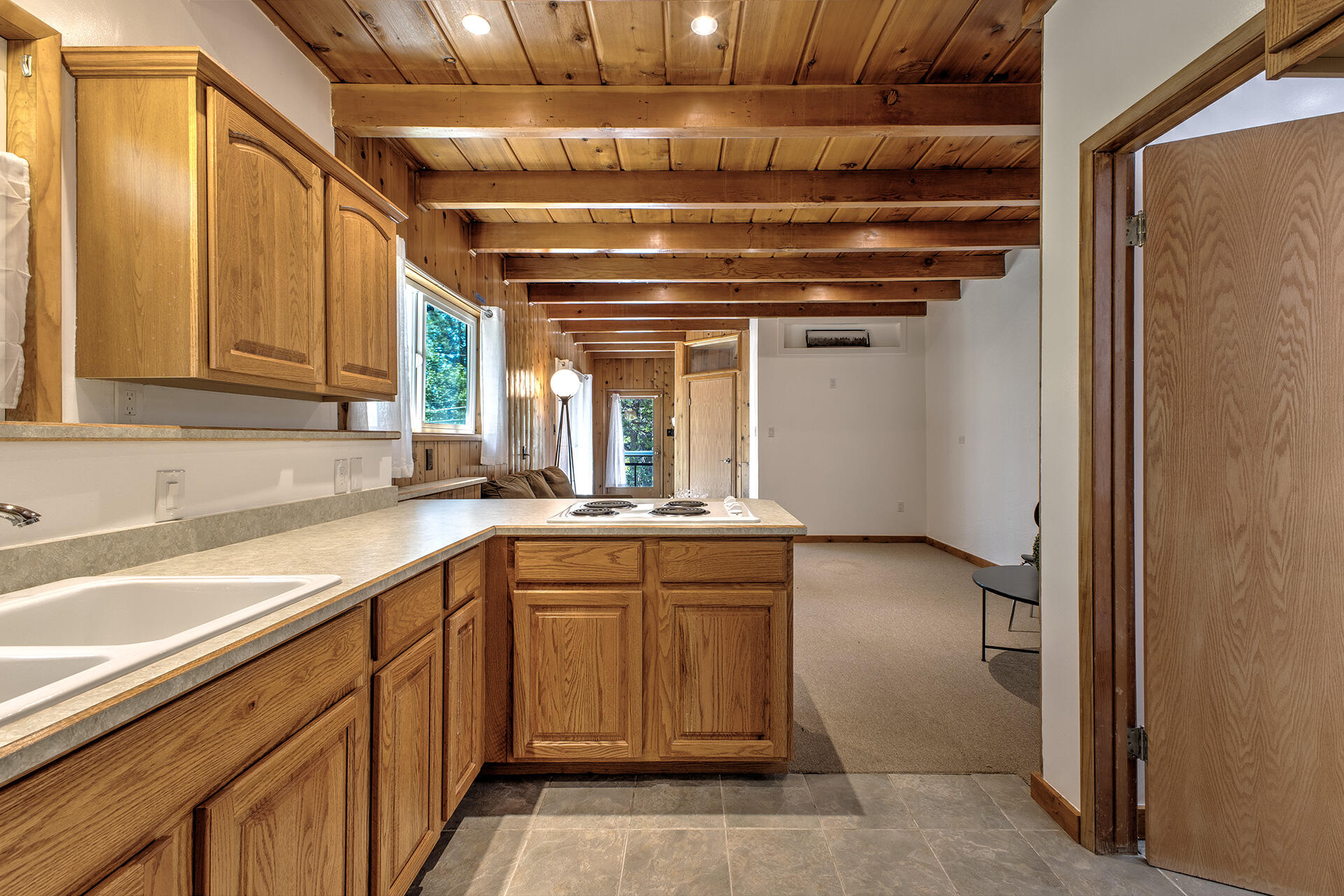 25460 Lodge Road Idyllwild, CA 92549 - Photo 47 of 78 a kitchen with a sink and cabinets