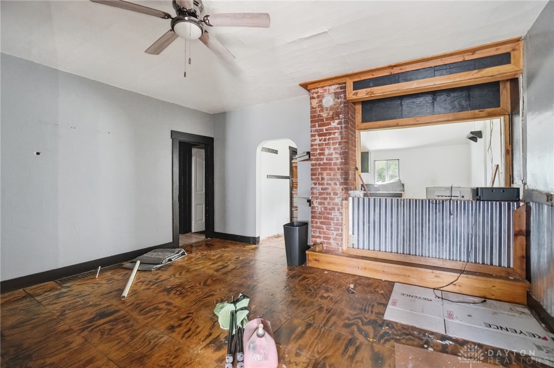 517 Broadway Street, Unit 515 Springfield, OH 45504 - Photo 5 of 29 This living room features rich wood flooring, a ceiling fan, and exposed brickwork.
