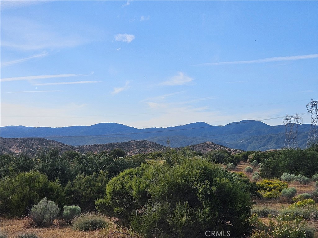 0 Outpost Road Oak Hills, CA 92344 - Photo 3 of 6 a view of a lush green field with mountains in the background