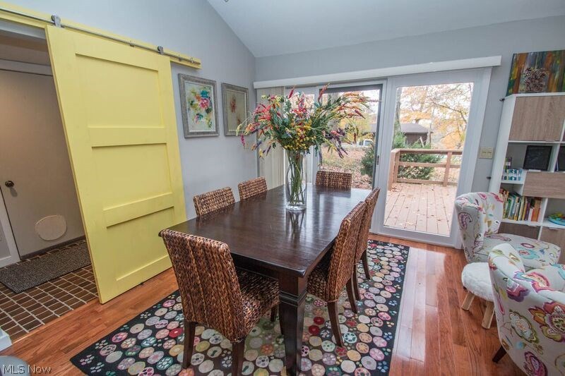 1007 Stewart Road Kent, OH 44240 - Photo 5 of 35 Dining area that leads to the deck. Also behind the bar door is a door to the garage. Half bath also located there. There are stairs going up to another bedroom.