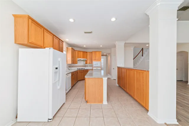 a kitchen with stainless steel appliances granite countertop a refrigerator and a sink