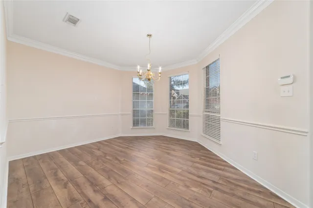 a view of wooden floor and windows in a room