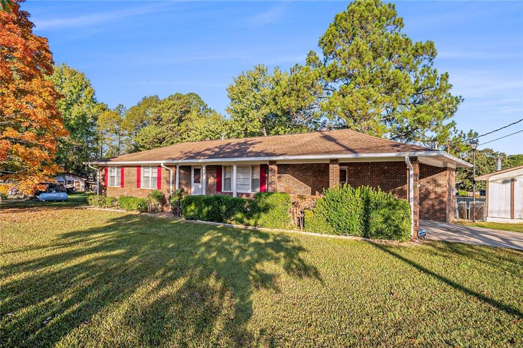 414 Stringer Road Rockmart, GA 30153 - Photo 1 of 1 a front view of a house with a yard table and chairs